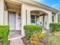 Inviting front entrance with a covered porch, neat landscaping, and a well-maintained walkway at 3620 Tresto St, New Smyrna Beach, FL 32168