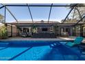 Screened-in pool with comfortable lounge chairs and an outdoor seating area for relaxation and entertaining at 464 Nash Ln, Port Orange, FL 32127