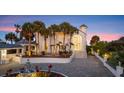 Beautiful home boasts an elegant entrance, a circular driveway, and lush landscaping at 4911 S Atlantic Ave, Ponce Inlet, FL 32127