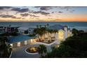 Panoramic shot of a beautiful two-story home with a three-car garage near a pristine beach at dusk at 4911 S Atlantic Ave, Ponce Inlet, FL 32127