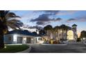 Gorgeous home featuring a circular driveway, a three-car garage, and mature landscaping at 4911 S Atlantic Ave, Ponce Inlet, FL 32127