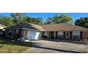 Lovely single story brick home with an attached garage and a double-wide driveway at 520 Dixson St, Orange City, FL 32763