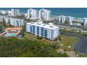 Scenic aerial view of the condo, green spaces, beachfront parking, and the Atlantic Ocean backdrop at 5300 S Atlantic Ave # 17-303, New Smyrna Beach, FL 32169