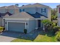 Charming two-story home with brick driveway, manicured lawn, and attached two-car garage at 544 Red Rose Ln, Sanford, FL 32771