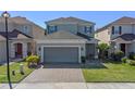 Charming two-story home with brick driveway, manicured lawn, and attached two-car garage at 544 Red Rose Ln, Sanford, FL 32771