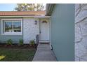 Close up view of the front door with decorative trim and landscaping at 597 Gainsboro St, Deltona, FL 32725