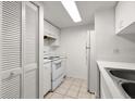 Clean kitchen with white appliances, cabinets, and ample storage space at 678 Wellington Station Blvd # 54, Ormond Beach, FL 32174