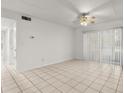 Bright living room area features tile flooring, a ceiling fan, and sliding glass doors at 678 Wellington Station Blvd # 54, Ormond Beach, FL 32174