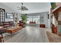 Cozy living room showcasing hard wood floors, comfortable leather seating and lots of light at 725 Briarcrest Dr, Orange City, FL 32763