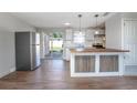 Modern kitchen with stainless steel appliances, wood floors, and a butcher block island at 852 Derbyshire Rd, Daytona Beach, FL 32117