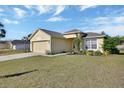 Well-kept single-story home with a manicured lawn and an attached two-car garage at 3430 Arabesque Dr, Deland, FL 32724