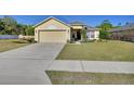 Inviting single-story home with a well-maintained lawn and an attached two-car garage at 3430 Arabesque Dr, Deland, FL 32724