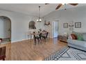 Inviting living room with wood floors, dining table, and cozy decor for a comfortable atmosphere at 3430 Arabesque Dr, Deland, FL 32724