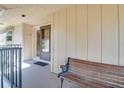 Inviting front porch with a wooden bench and a screen door at 120 Hibiscus Woods Ct # 14D, Deltona, FL 32725