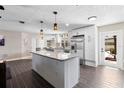 Bright, open kitchen featuring a granite-topped island and stainless steel appliances at 1254 Mardrake Rd, Daytona Beach, FL 32114