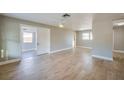 Spacious living room featuring new light wood flooring, a neutral color palette, and ample natural light at 1304 Genmar St, Daytona Beach, FL 32117