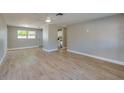 Inviting living room with light wood flooring, freshly painted walls, and an open layout to the kitchen at 1304 Genmar St, Daytona Beach, FL 32117