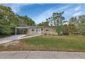 Charming single-story home featuring a cozy front porch and a convenient covered carport at 1434 Deltona Blvd, Deltona, FL 32725