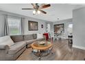 Comfortable living room with a ceiling fan, wood-look flooring, and a connecting dining area at 1434 Deltona Blvd, Deltona, FL 32725