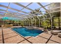Enclosed pool with hot tub and outdoor kitchen area for luxurious, private enjoyment at 1450 Shady Meadow Ln, Deland, FL 32724