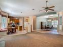Open-concept living area featuring a kitchen, dining area, and a large window with a breakfast nook at 1490 Kettledrum Trl, Enterprise, FL 32725