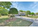 Beautiful front lawn featuring well-maintained landscaping and a driveway made of decorative pavers at 1512 Lancashire Way, Deland, FL 32720