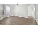 Spacious room with neutral walls, light hardwood floors, white trim, and light from the large window at 1540 Park Forest Blvd, Mount Dora, FL 32757