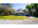 Beautiful one-story home with green lawn, complemented by mature trees, and attached one car garage at 1602 15Th St, Orange City, FL 32763