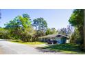 Inviting one-story home featuring manicured lawn, complemented by mature trees and one car garage at 1602 15Th St, Orange City, FL 32763