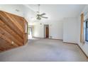 Bright living room with a ceiling fan, and a rustic wood breakfast bar facing the kitchen at 2017 Monterey Dr, Deltona, FL 32738