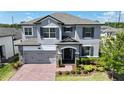 Beautiful two-story home with manicured landscaping, a brick driveway, and an inviting front entrance at 2090 Prairie Sage Ln, Longwood, FL 32750