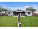 View of the screened in patio, backyard and fence at 2415 India Palm Dr, Edgewater, FL 32141