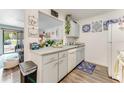 Bright kitchen featuring white cabinets, updated countertops, and a breakfast bar, open to the living area at 2704 Oak Trail Run # 4, Port Orange, FL 32127