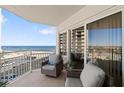 Relaxing balcony offers stunning ocean views with comfortable seating, perfect for enjoying morning coffee or evening sunsets at 2967 S Atlantic Ave # 301, Daytona Beach Shores, FL 32118