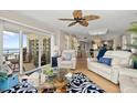 Bright living room with modern furnishings, elegant decor, and sliding glass doors to the ocean-view balcony at 2967 S Atlantic Ave # 301, Daytona Beach Shores, FL 32118