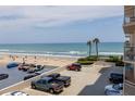 Expansive beach view from the property highlighting beach access and parking area at 2967 S Atlantic Ave # 301, Daytona Beach Shores, FL 32118