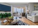 Comfortable living room featuring beach view, a large television, and stylish decor at 2967 S Atlantic Ave # 301, Daytona Beach Shores, FL 32118