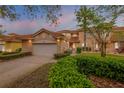 Charming townhome featuring a red tile roof, two-car garage and lush landscaping at 3145 Connemara Dr, Ormond Beach, FL 32174