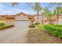 Charming townhome featuring a red tile roof, two-car garage and lush landscaping at 3145 Connemara Dr, Ormond Beach, FL 32174