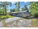 Exterior view of a home with a long driveway and well-kept yard at 321 Wade Ave, Deland, FL 32724