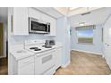 Well-equipped kitchen boasting updated appliances and ample counter space with tile floors at 3333 S Atlantic Ave # 2202, Daytona Beach, FL 32118