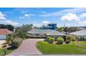 Charming single-story home with a brick driveway and lush green lawn at 36 Sand Dollar Dr, Ormond Beach, FL 32176