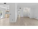 Open-concept living area with tile flooring, neutral walls, and modern lighting at 36 Sand Dollar Dr, Ormond Beach, FL 32176