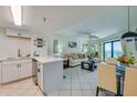 Comfortable living room adjacent to a white kitchen, showcasing an open floor plan at 3647 S Atlantic Ave # 5B, Daytona Beach, FL 32118