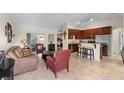 Open-concept living space with a kitchen, living room, and view of a bedroom at 3825 Arborvitae Way, Deland, FL 32724