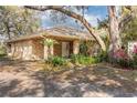 Welcoming brick home featuring a covered front porch and lush landscaping at 50 Lake Dr # 1/2, Debary, FL 32713