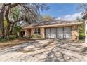 Charming brick home with attached two-car garage and mature landscaping at 50 Lake Dr # 1/2, Debary, FL 32713