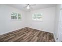 Bright bedroom with hardwood flooring, white walls, and plenty of natural light from shuttered windows at 511 Powers Ave, Port Orange, FL 32127