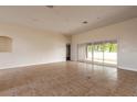 Bright living room featuring tile floors and sliding glass doors to the outdoor area at 69 Grey Dapple Way, Ormond Beach, FL 32174