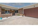 Inviting front porch with seating area leads to a brick home with a 2 car garage at 7 Kathy Dr, Ormond Beach, FL 32176